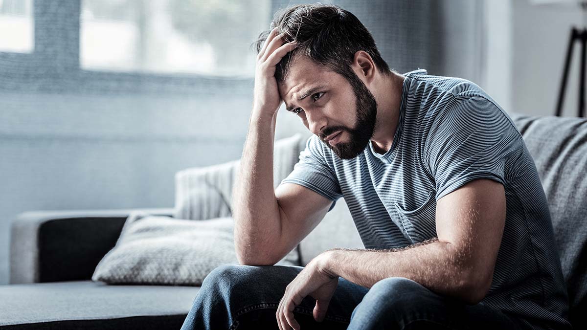 Unpleasant,Pain.,Sad,Unhappy,Handsome,Man,Sitting,On,The,Sofa