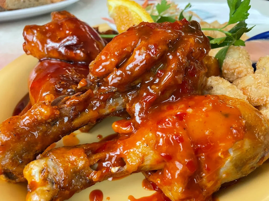 Wings and sauce on a plate.