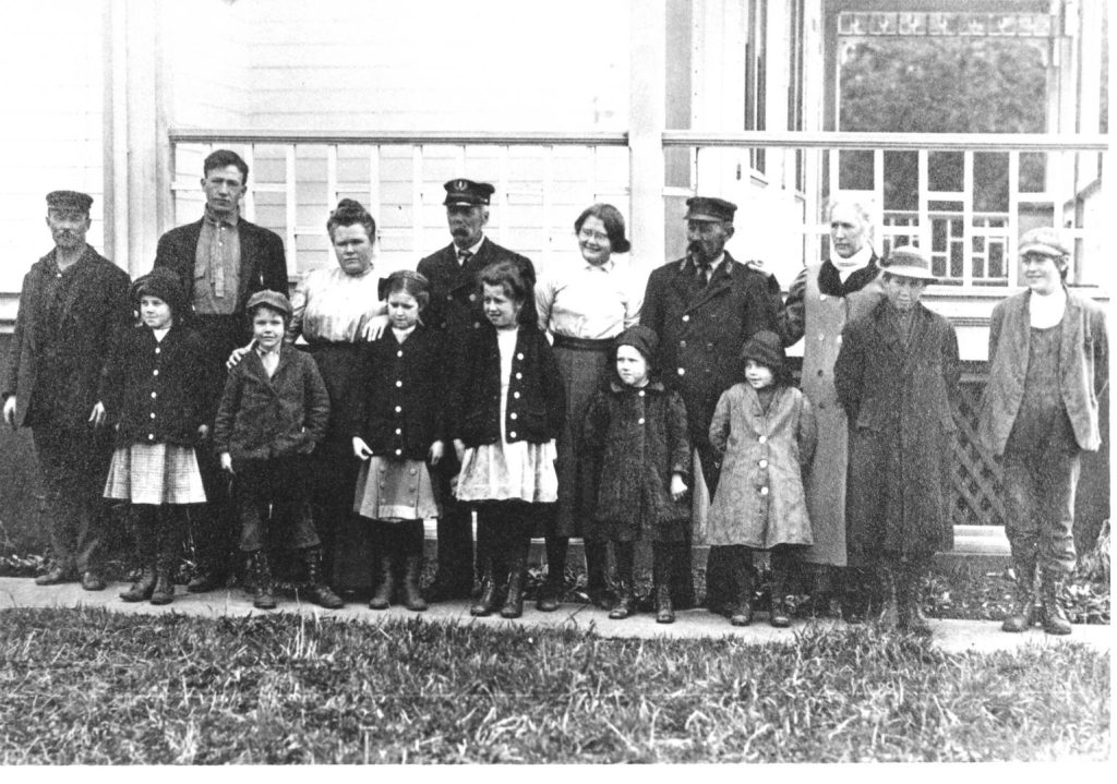 A black and white photo of several lightkeepers and their families at Heceta Head Lighthouse.