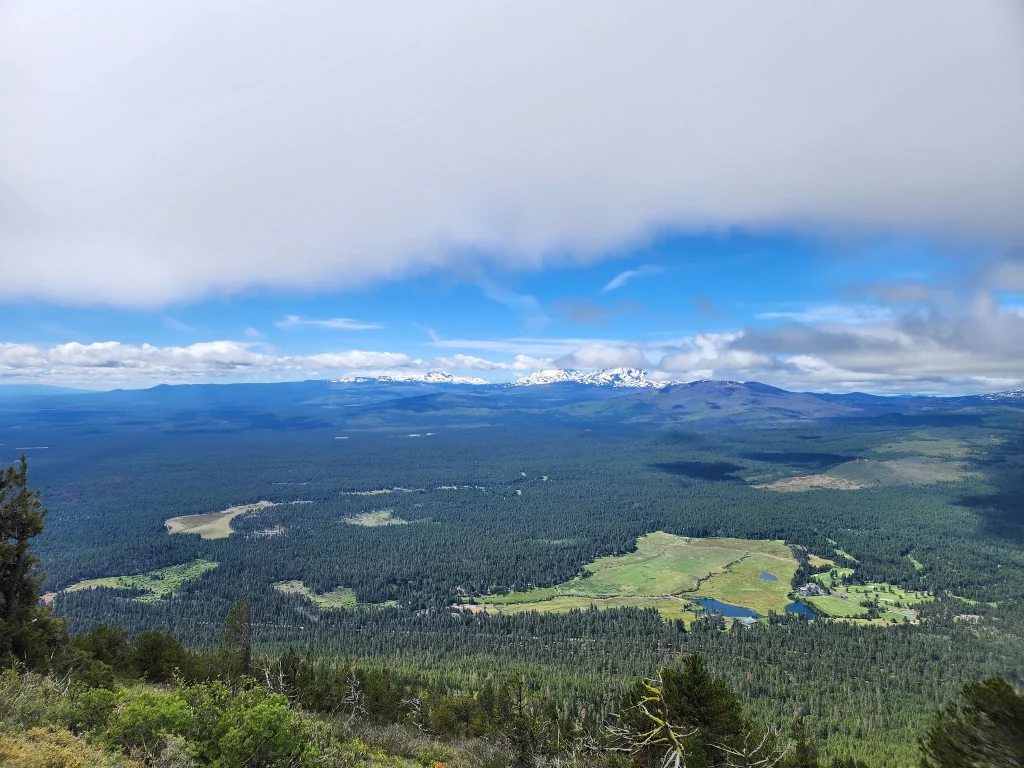 The view from the top of Black Butte in Oregon. Black Butte Ranch and golf course can be seen at the bottom of the mountain as a grassy clearing in the forest.
