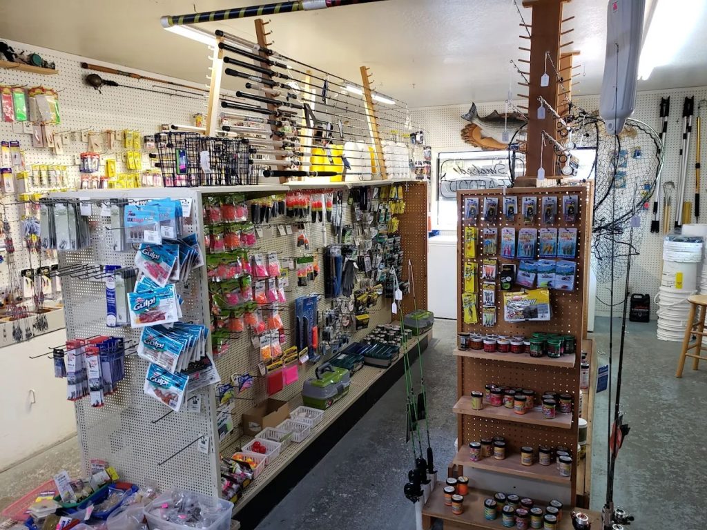 Fresh bait and tackle supplies displayed inside Bandon Bait shop in Bandon, Oregon, with fishing gear and coastal equipment near the bayfront dock.