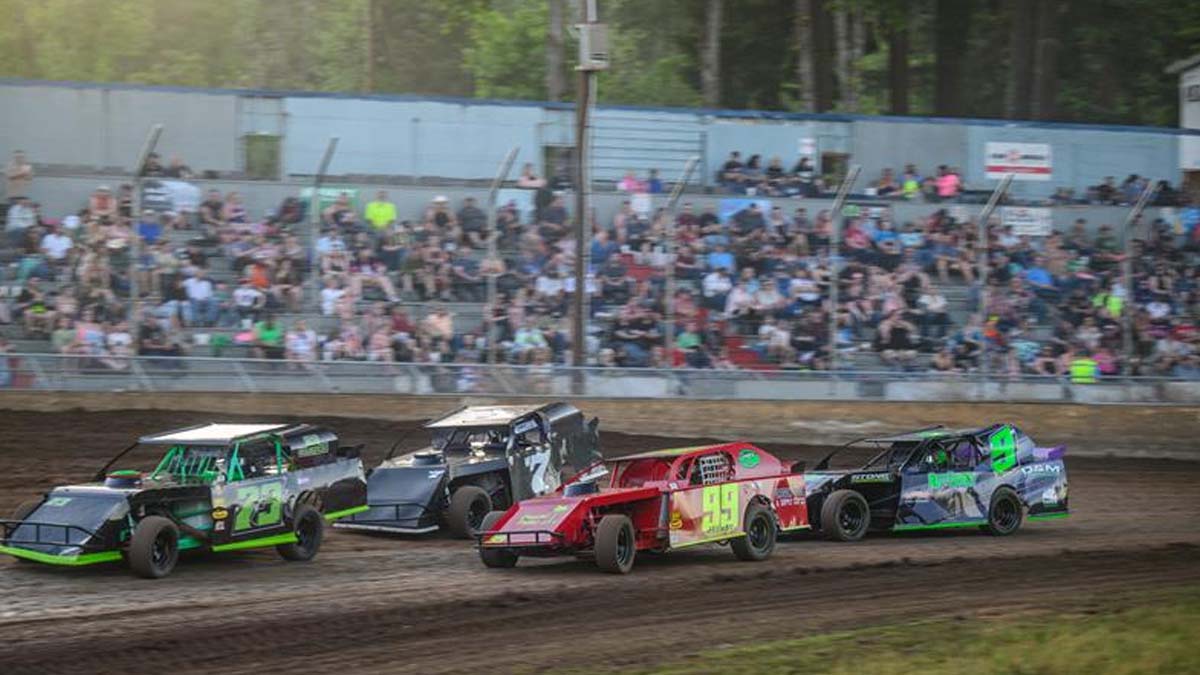 0-main-grove Race cars kicking up dirt during an event at Cottage Grove Speedway.