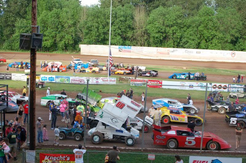 Race cars kicking up dirt during an event at Cottage Grove Speedway.