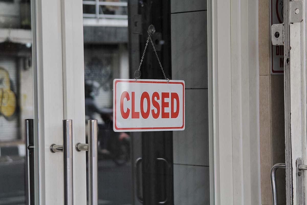 Closed,Sign,On,Glass,Door,Indicating,Business,Closed,For,Day